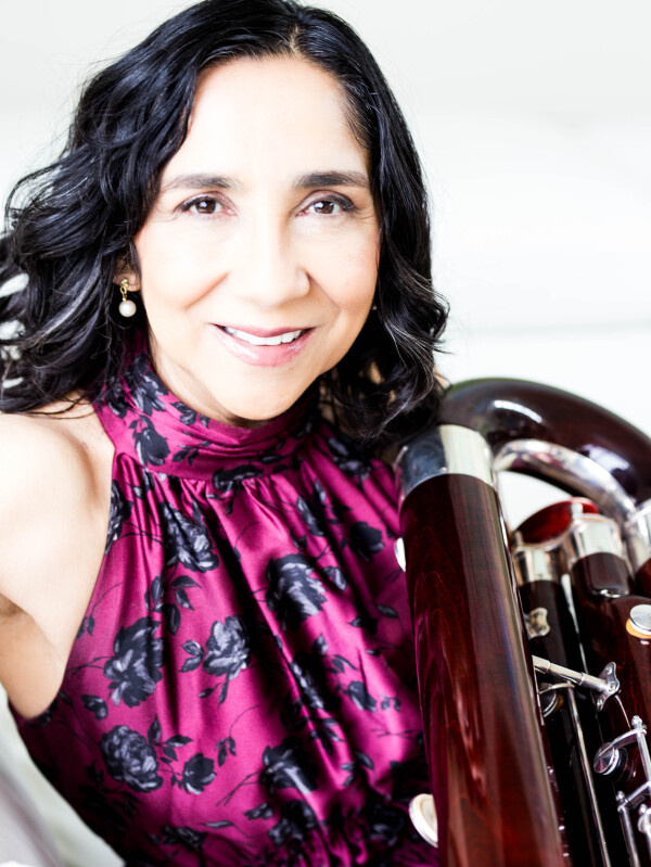 Leyla Zamora bassoonist headshot featuring contrabassoon.
